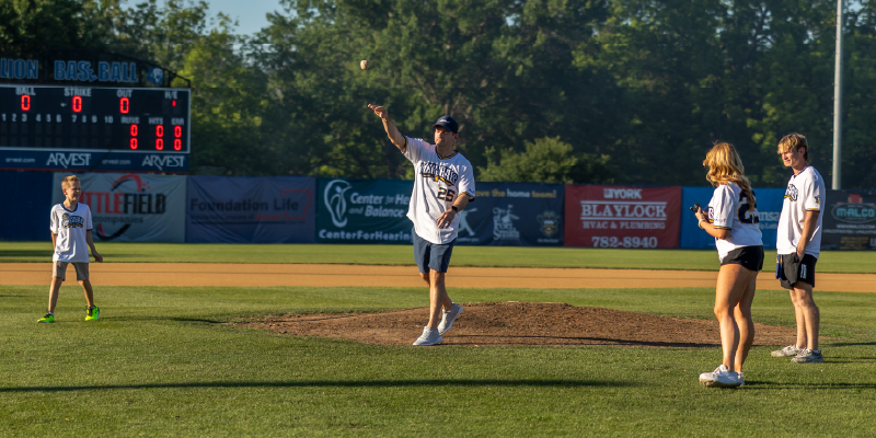 ArcBest president, Seth Runser, throwing the first pitch at a Fort Smith Marshals game